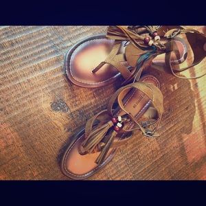 Suede  sandals with feather and bead detail.